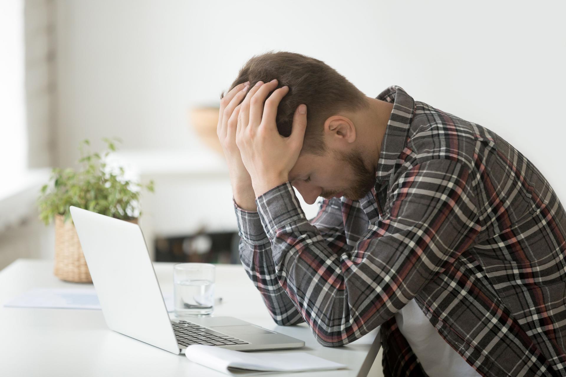 Frustrated depressed man shocked by online bankruptcy or stock downfall