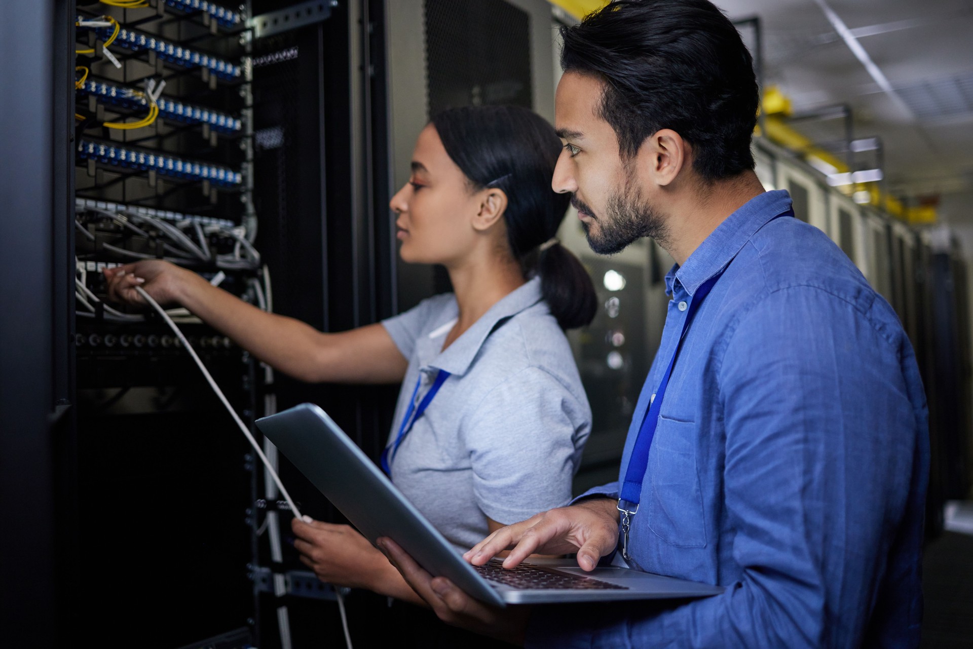 Man, woman or server room maintenance on laptop IT, software programming ideas or cybersecurity engineering. People, repair or data center technology in teamwork collaboration of safety analytics fix